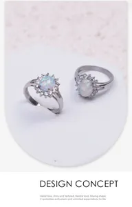 Detail view of 316L stainless steel sunflower rings with iridescent oval opal stones