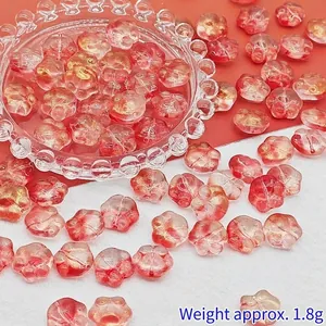 Close-up of 14mm gradient red glass cat paw beads showing gold foil texture for DIY jewelry.