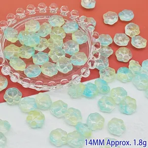 Close-up of cute gradient blue and yellow glass cat paw beads for DIY jewelry making