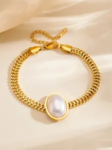 Vintage gold-plated titanium steel bracelet featuring a large oval faux pearl center.