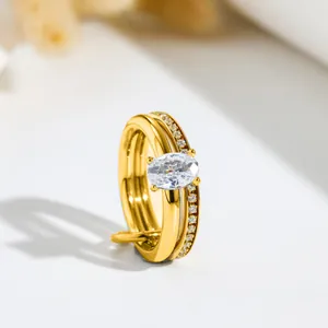 Close-up of golden double-layer stainless steel ring with elegant oval cubic zirconia