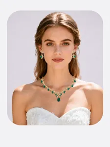 Luxury bridal jewelry set featuring green teardrop crystals on an elegant model