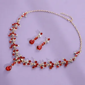 Elegant vintage royal gold-tone necklace and earring set with vibrant red crystals