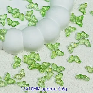 Macro view of green glass butterfly beads with gold foil for DIY crafts, 15x10mm size