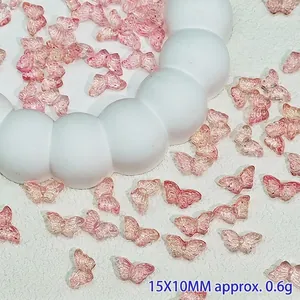 Close-up of pink translucent butterfly glass beads for DIY hair accessories.