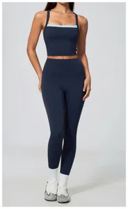 Close-up of high-waisted navy yoga leggings and matching contrast-trim sports bra set