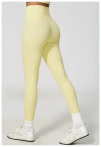 Back view of high-waisted yellow yoga leggings with a push-up fit
