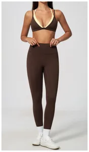 Full body view of model wearing high-waisted brown fitness leggings and sports bra set