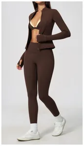 Close-up of brown high-waisted butt-lifting yoga leggings and matching jacket set