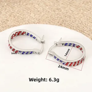 Macro detail of teardrop hoop earrings with red blue crystals and measurement labels