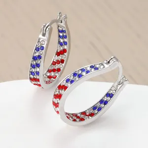 Detail view of rhinestone hoop earrings in red white and blue American flag colors