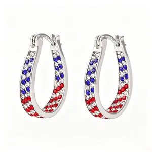 Macro view of U-shaped hoop earrings with red white and blue rhinestones for Independence Day