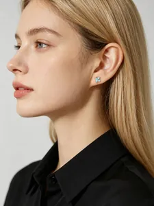 Side view detail of small blue flower S925 silver stud earrings worn by a model