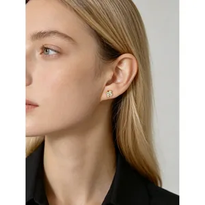 Model wearing S925 sterling silver flower stud earrings featuring sparkling crystals