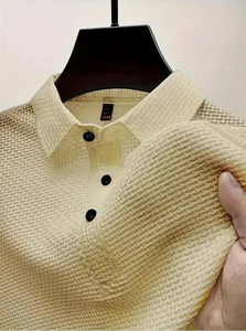 Macro view of men's polo shirt showing the textured ice silk mesh fabric and buttons