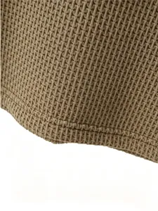 Macro detail of breathable waffle knit fabric on men's khaki ice silk polo t-shirt