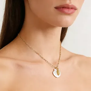 Gold plated stainless steel necklace with white shell and conch pendant on female neck