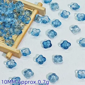 Close-up of 10mm blue glass flower beads, perfect for DIY jewelry and hair accessories