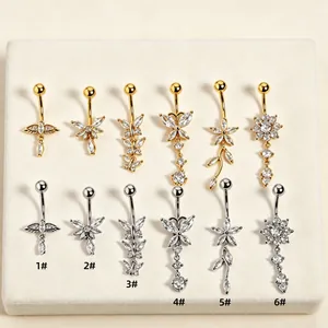 Detailed view of zircon butterfly and flower tassel belly rings in gold and silver