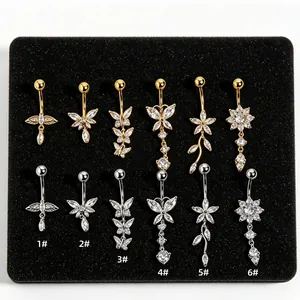Close-up view showing six different styles of zircon belly button rings in gold and silver