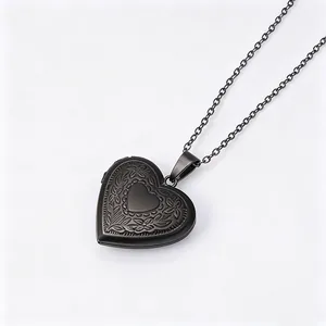 Macro shot of black stainless steel heart locket necklace with vintage floral engraving