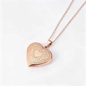 Close-up detail of a rose gold heart locket necklace with intricate floral pattern