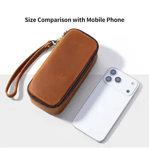Vintage brown leather pipe tobacco pouch shown next to a smartphone for size comparison