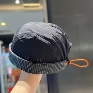 Close-up of a black vintage quick-dry five-panel hat featuring a checkered brim detail.
