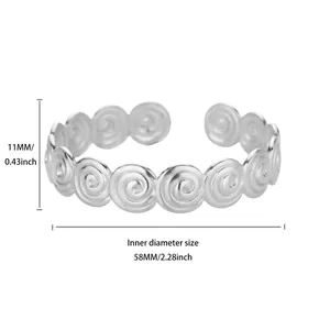 Detail view of silver swirl pattern titanium steel open bracelet showing 58mm diameter