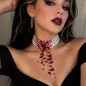 Detailed macro shot of gothic pearl choker necklace featuring red blood drip bead tassels