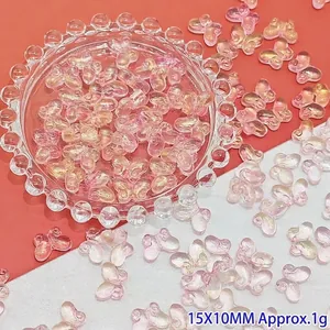 Close-up of pink gradient glass butterfly beads for DIY earrings and handmade jewelry