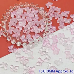 Detail view of translucent pink gradient butterfly glass beads for DIY jewelry crafts
