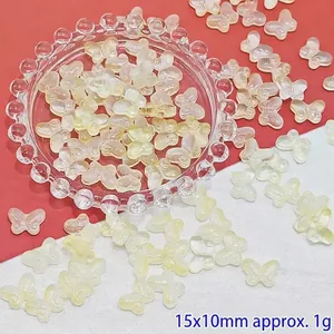 Macro detail of yellow gradient glass butterfly beads for DIY jewelry and earring making