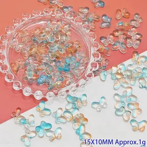 Detailed view of translucent blue and orange gradient butterfly beads for DIY jewelry