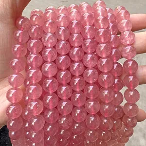 Detailed macro shot of natural translucent pink round stone beads for jewelry crafting
