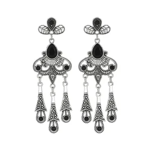 Detailed view of vintage silver teardrop tassel earrings with elegant black gemstones