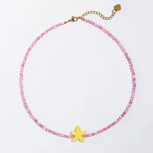 Vue détaillée du collier de perles roses avec un pendentif étoile de mer jaune vif