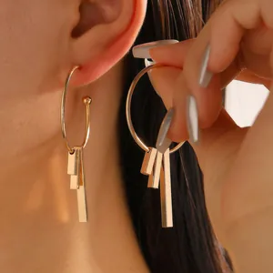 Minimalist geometric gold hoop earrings with dangling rectangular bars in polished finish