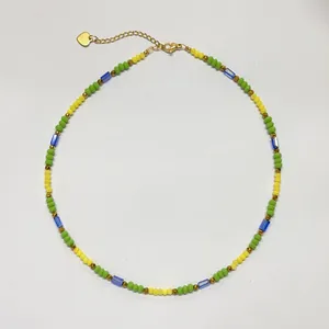 Detail view of a colorful beaded choker necklace with green, yellow and blue stones