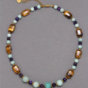 Close-up detail of natural tiger eye and colorful gemstone beaded choker necklace