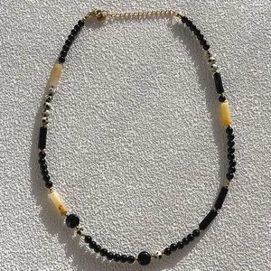 Detailed view of handmade natural stone beaded necklace with black and dalmatian beads