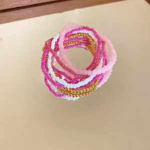 Bohemian 6-piece beaded bracelet set with pink, magenta, and metallic gold accents
