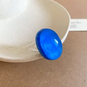 Minimalist vibrant cobalt blue oval resin ring featuring a clear geometric band design