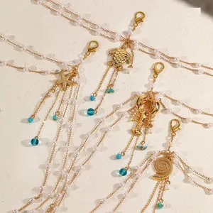 Close-up view of gold layered body chains featuring starfish, sea turtle, and seashell pendants