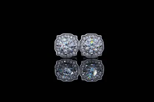 Detailed close-up of micro-pave moissanite silver stud earrings on reflective surface