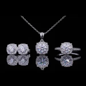 Elegant silver moissanite jewelry set with halo pendant necklace, earrings, and ring.