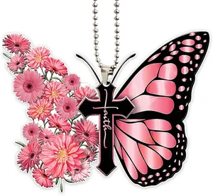 Detailed view of pink butterfly cross hanging ornament with faith script and flowers