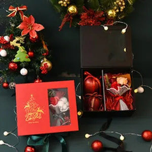 Detailed view of Christmas gift boxes containing festive apples and a small bouquet