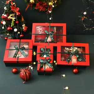 Detailed view of red Christmas gift boxes with transparent windows and green bows