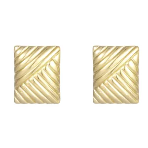 Macro detail of elegant gold square textured titanium steel stud earrings for women